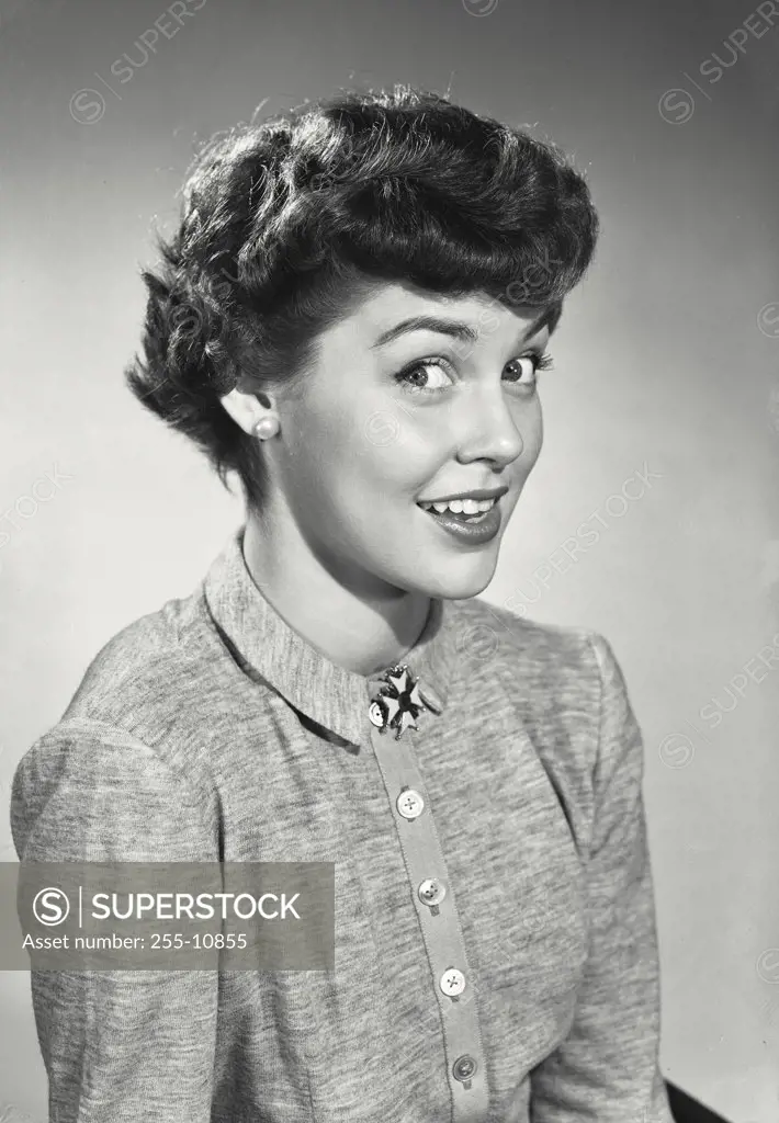Vintage photograph. Woman with short dark hair wearing button up blouse and brooch