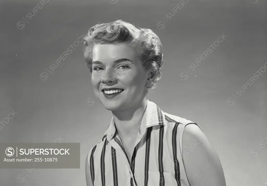 Vintage Photograph. Woman in tennis clothes smiling at camera