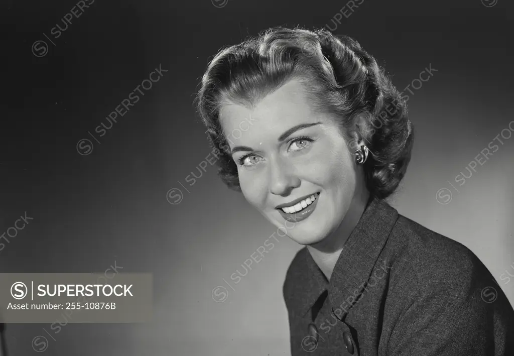 Vintage Photograph. Woman in coat smiling with head turned