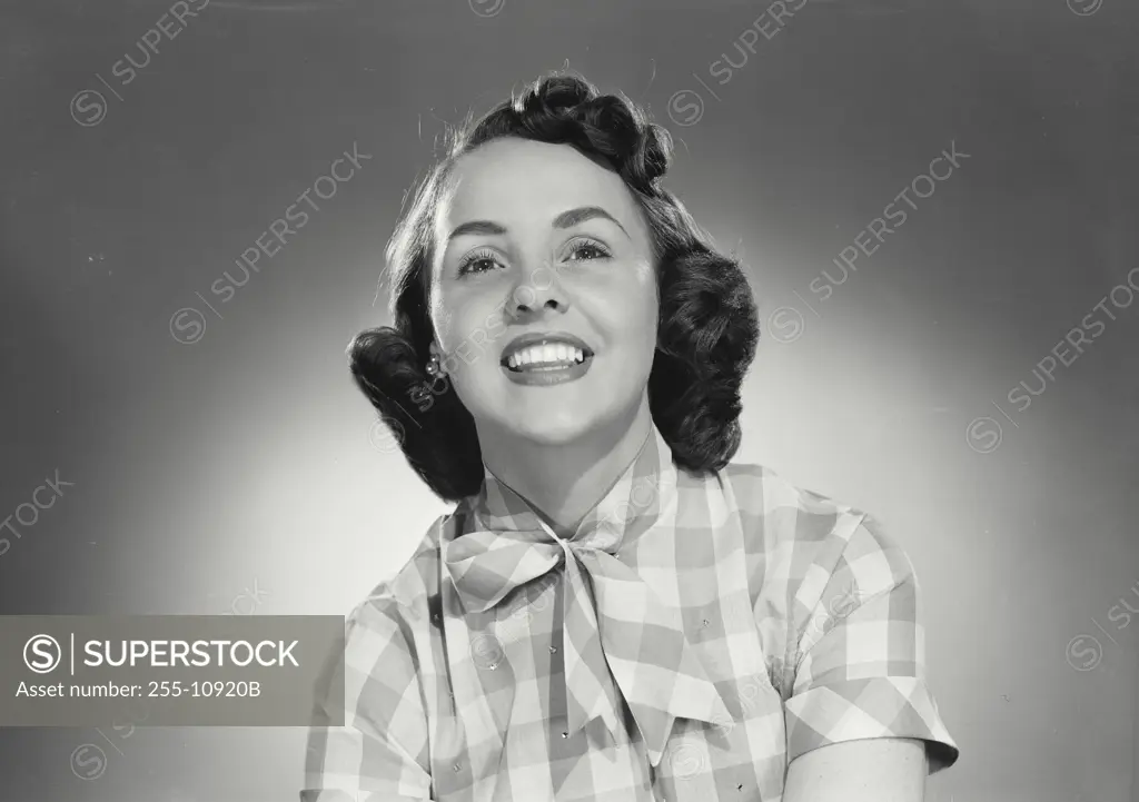 Vintage Photograph. Woman in plaid button shirt smiling wide at camera