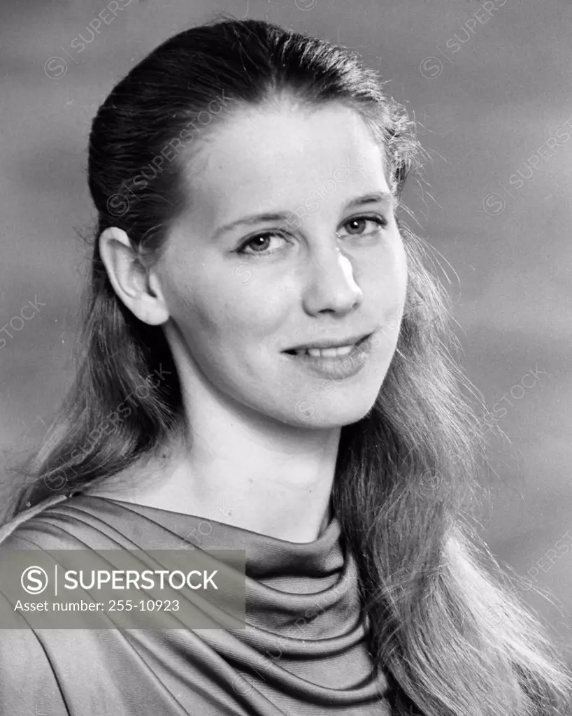 Studio portrait of young woman smiling