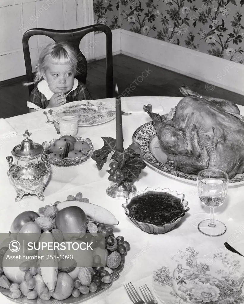 Little girl looking at Thankgsgiving Turkey