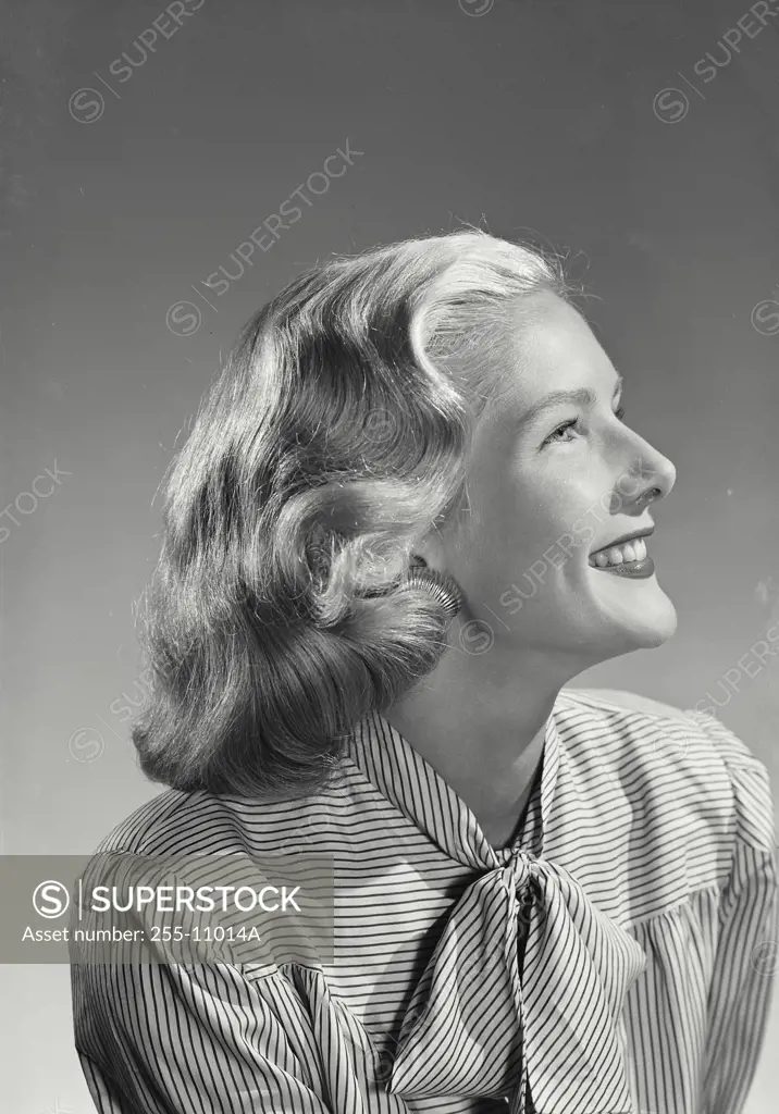 Vintage Photograph. Profile of woman in striped blouse with bow