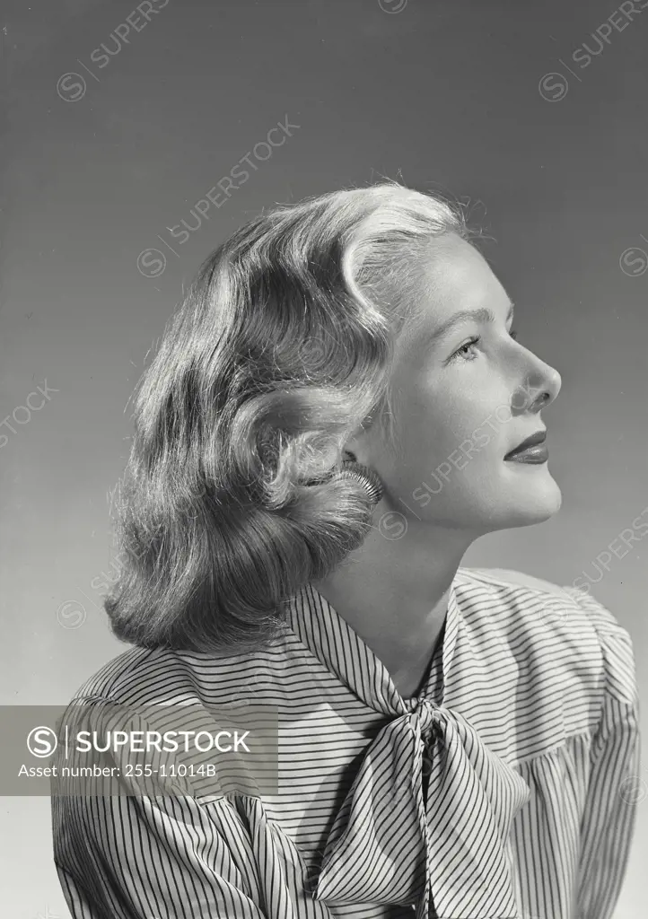 Vintage Photograph. Profile of woman in striped blouse.