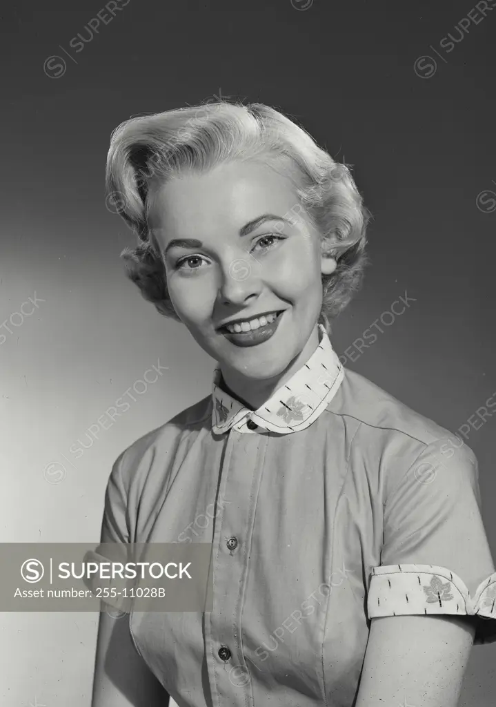 Vintage Photograph. Woman in button blouse smiling at camera. Frame 2
