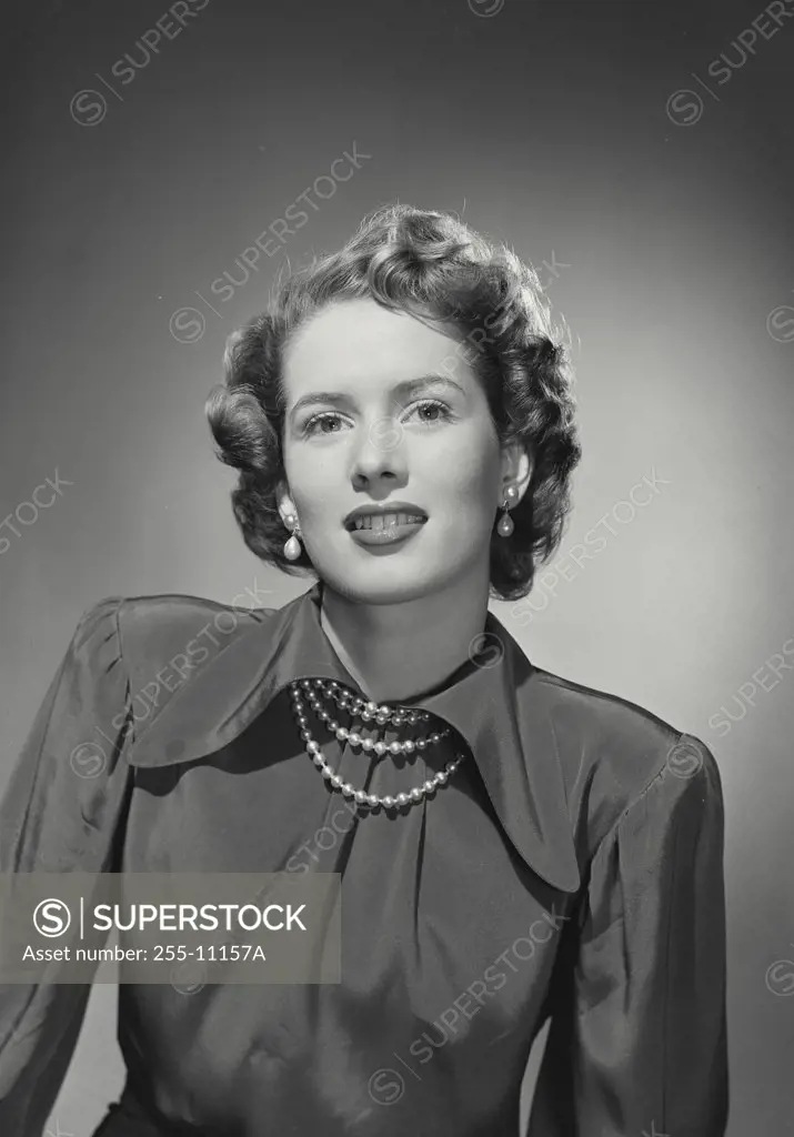 Vintage photograph. Woman wearing silk blouse and pearl necklace