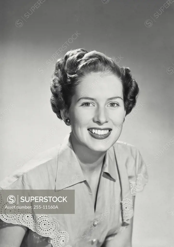 Vintage photograph. Woman in collared blouse smiling at camera