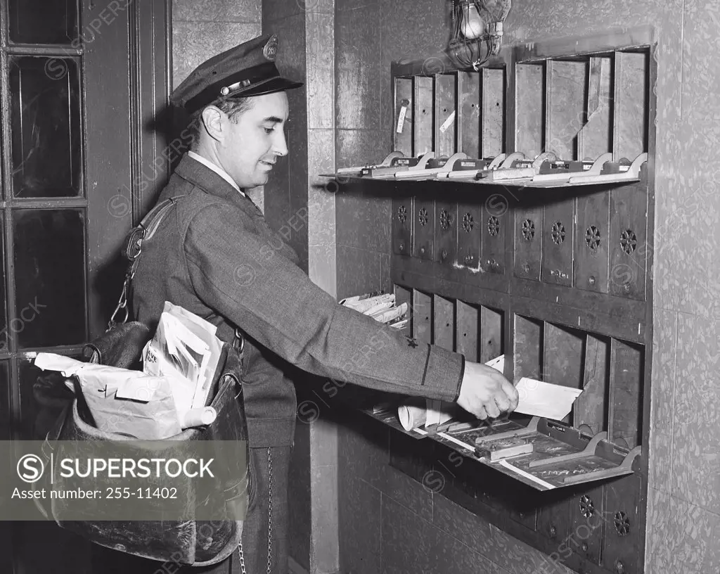 Mailman putting mail in mailboxes