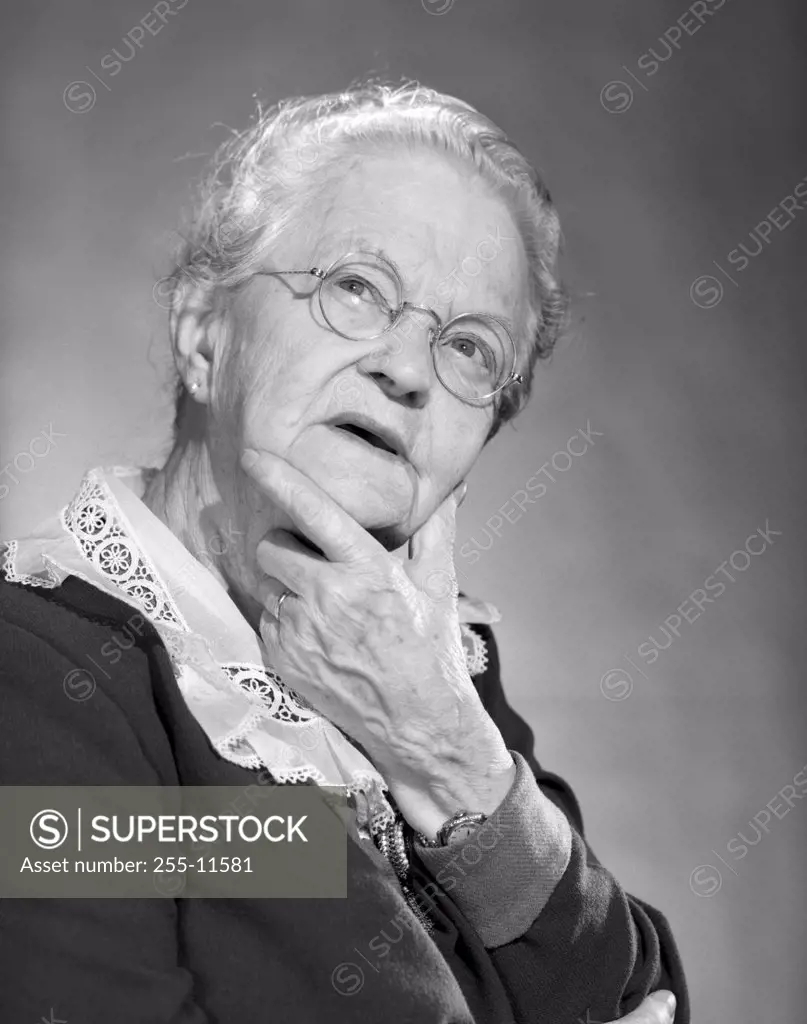 Senior woman with hand on chin