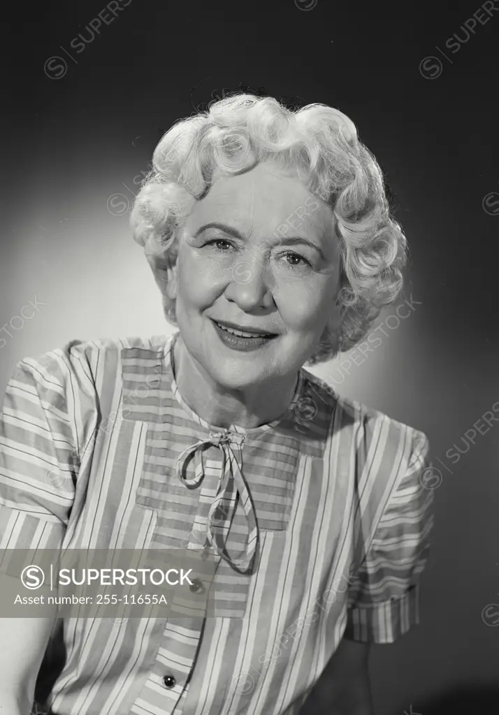 Vintage Photograph. Older woman in striped blouse smiling at camera. Frame 1