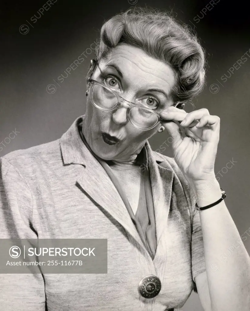 Studio portrait of senior woman puckering