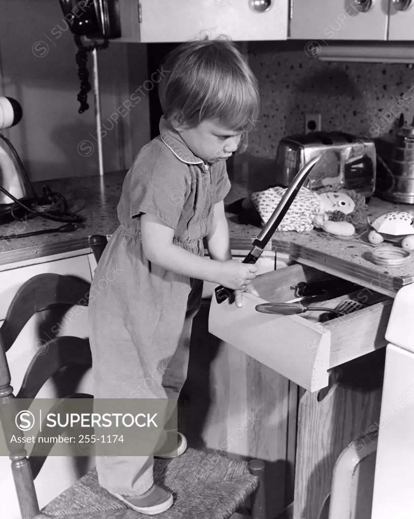 Boy looking at kitchen knife