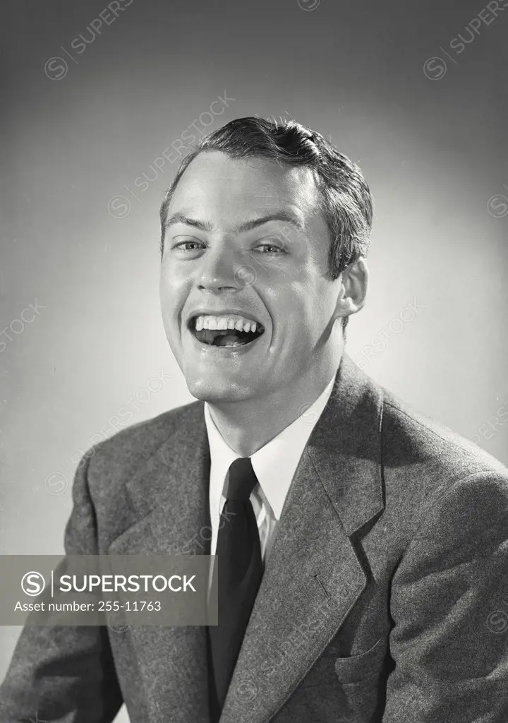 Vintage photograph. Man in suit and tie with huge smile