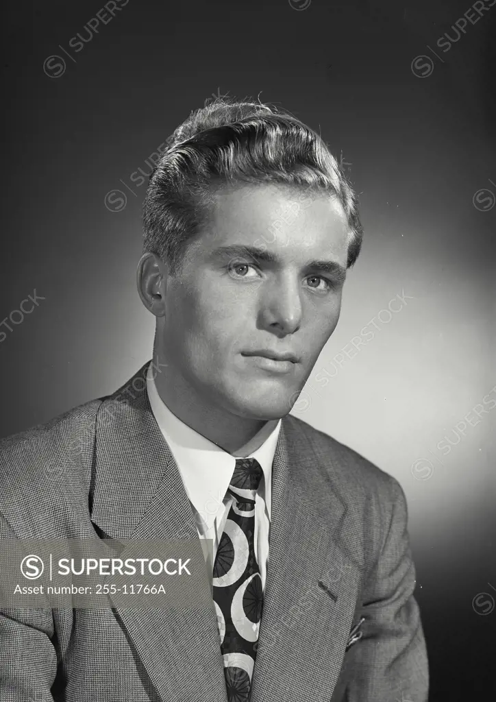 Vintage Photograph. Blonde man wearing suit and tie with serious expression