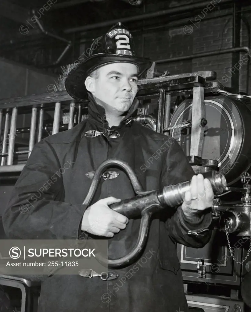 Close-up of a firefighter holding a fire hose