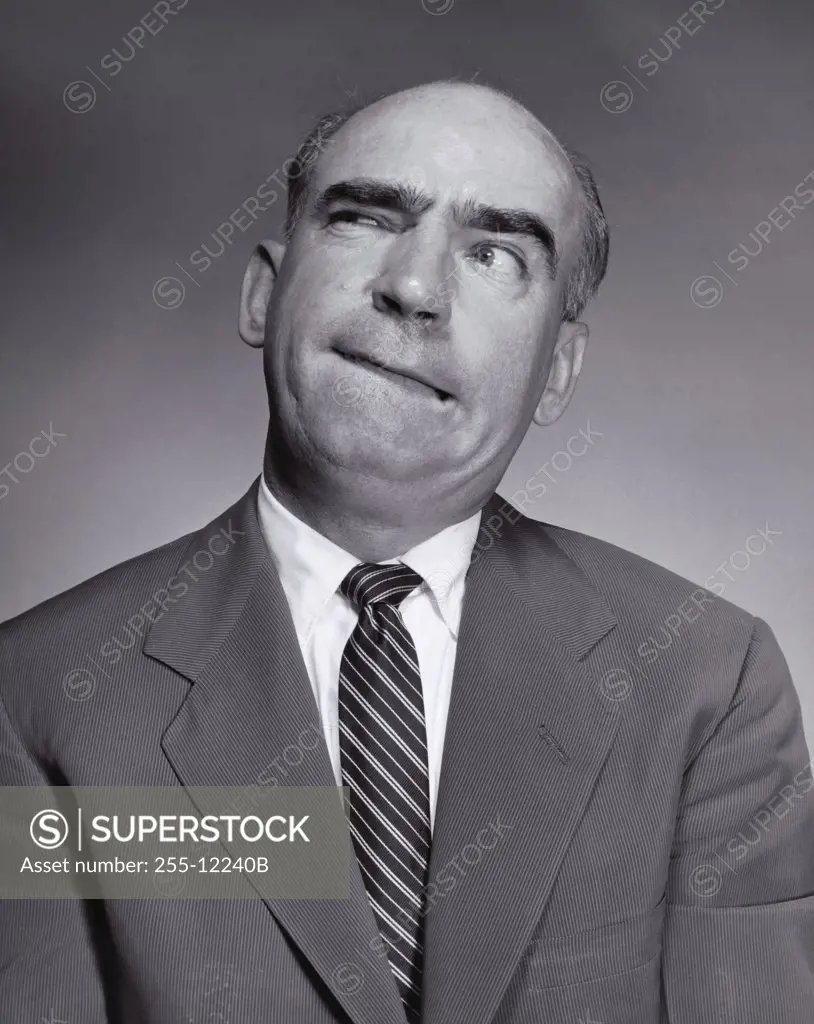Businessman biting his lips and squinting