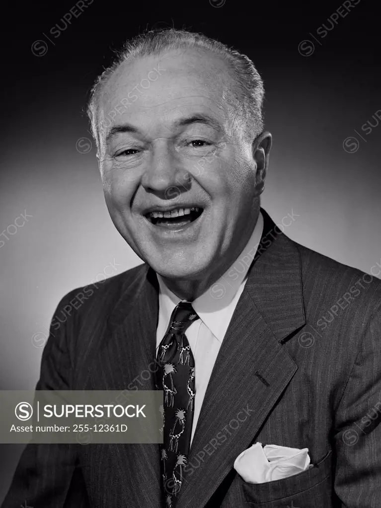 Studio portrait of businessman laughing