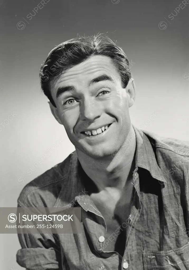 Vintage photograph. Portrait of man in button shirt smiling.
