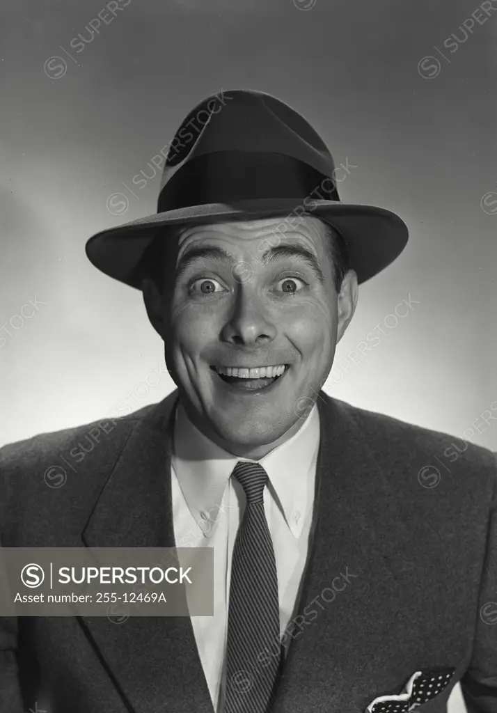 Vintage Photograph. Man in suit and hat smiling at camera. Frame 1