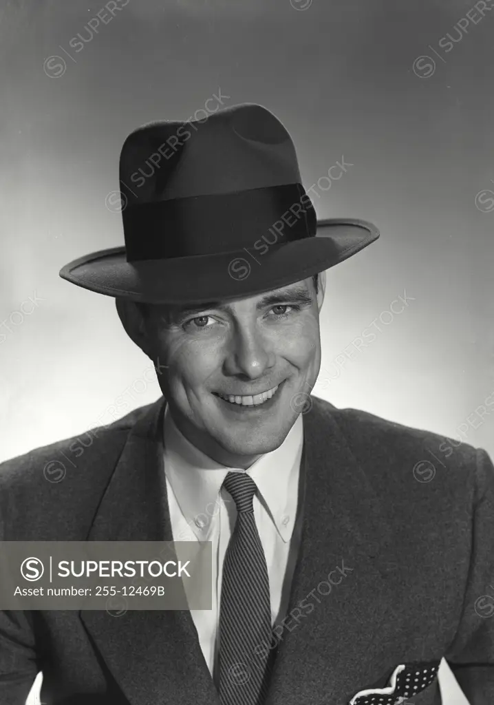 Vintage Photograph. Man in suit and hat smiling at camera. Frame 2