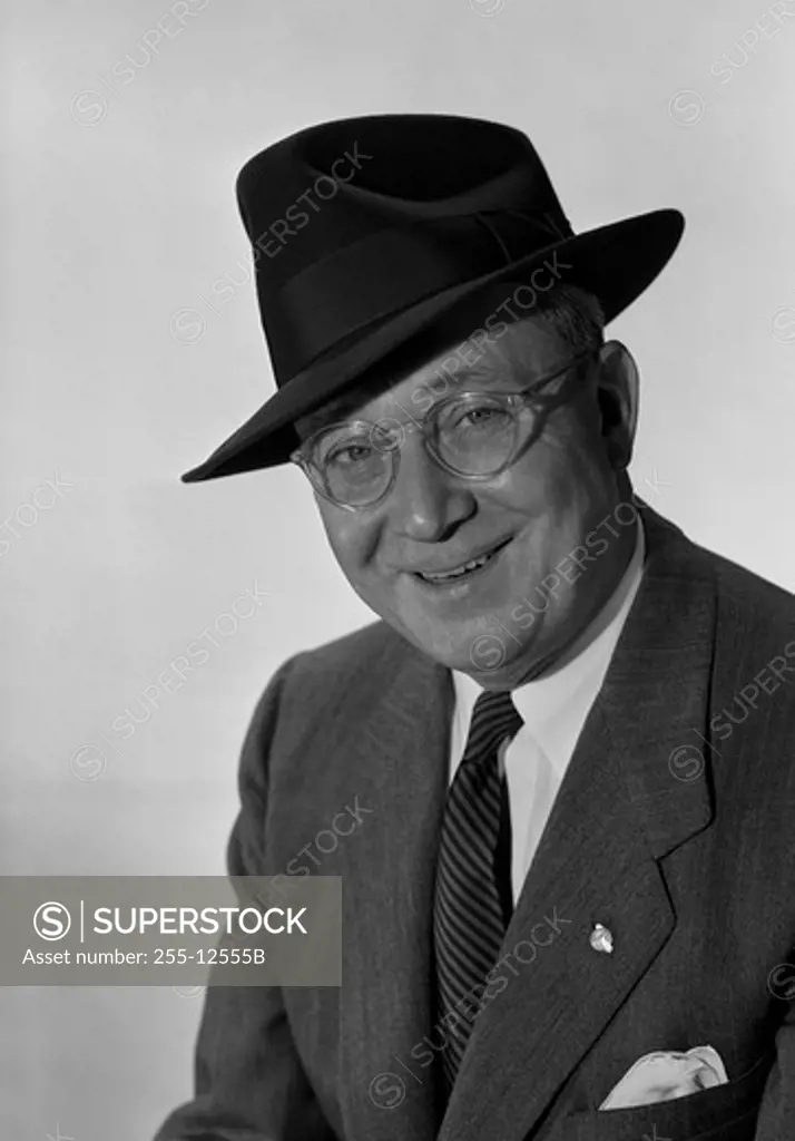 Studio portrait of senior man in hat