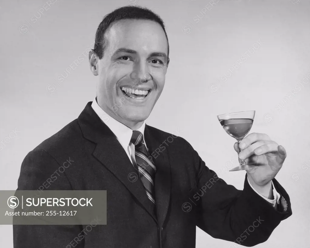 Portrait of a mature man holding martini