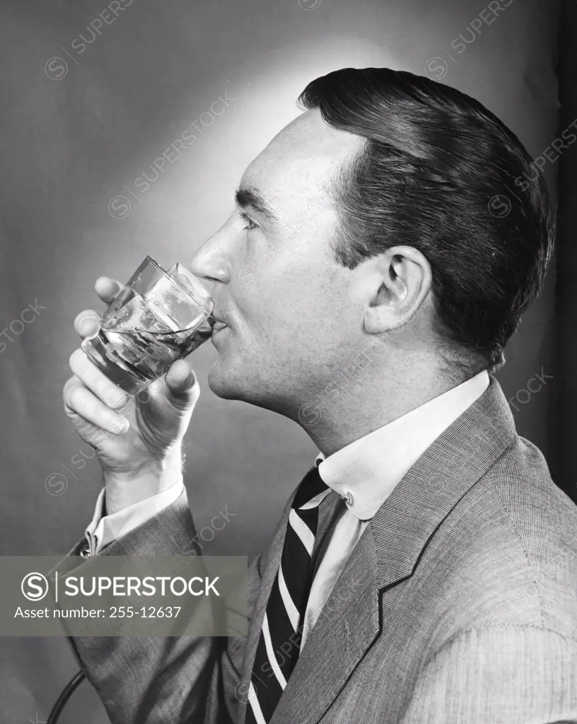 Side profile of a mature man drinking