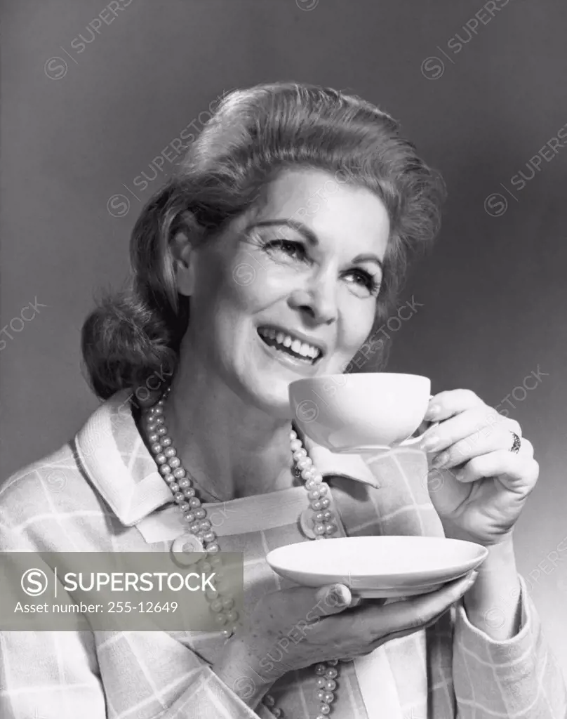 Close-up of a mature woman drinking from a tea cup