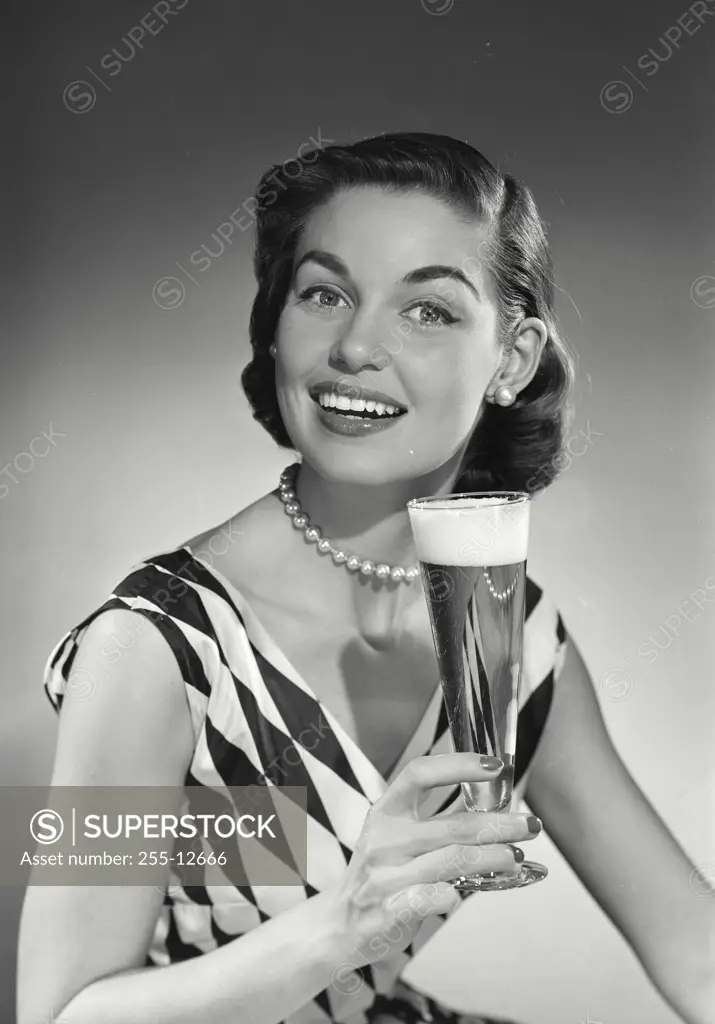 Vintage Photograph. Model in checkered blouse holding beer
