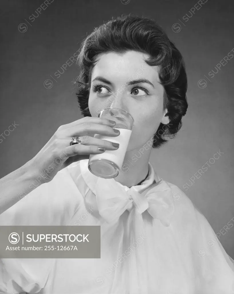 Close-up of a young woman drinking milk