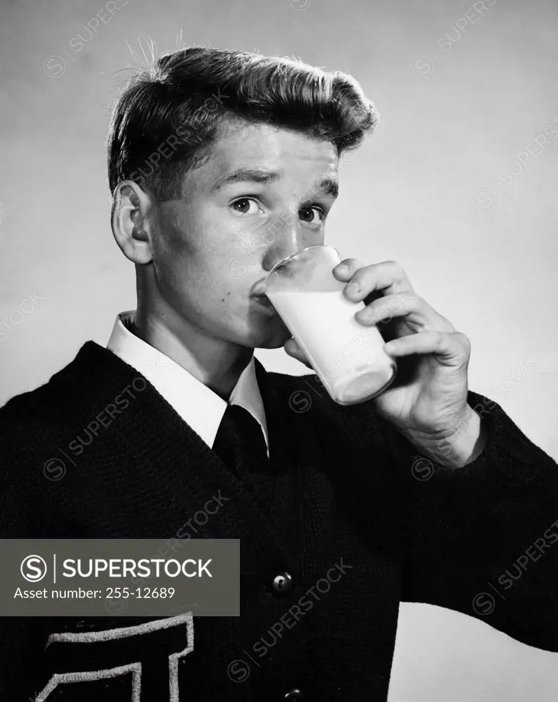 Portrait of a young man drinking milk