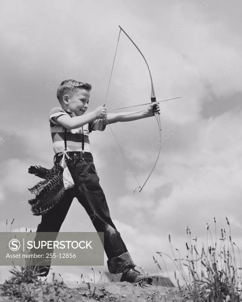 Boy aiming bow and arrow