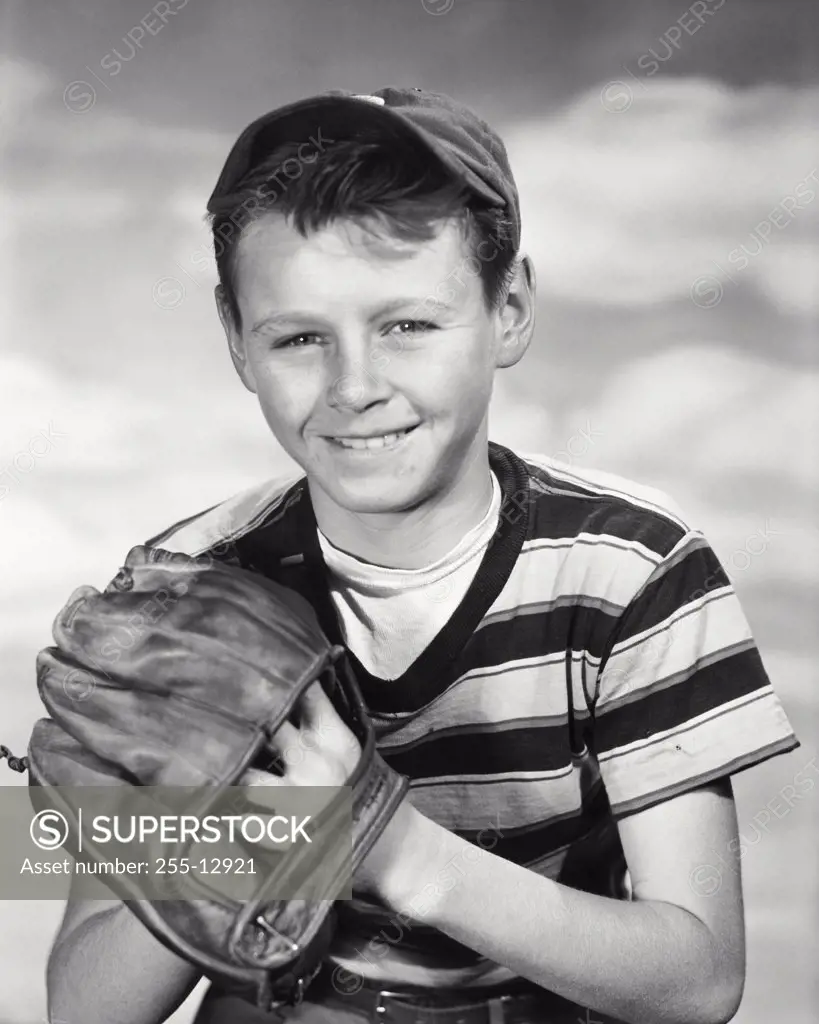 Portrait of a smiling boy holding a baseball glove