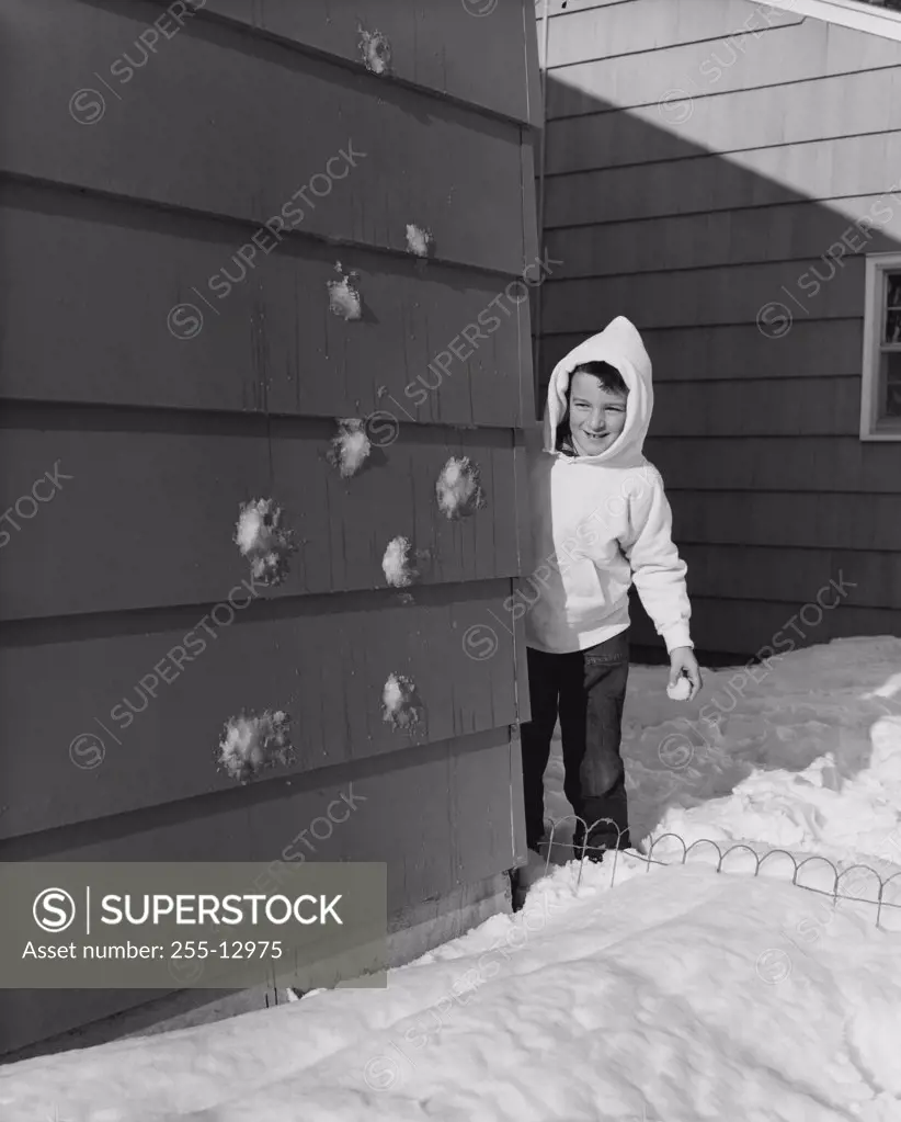 Boy standing behind a wall
