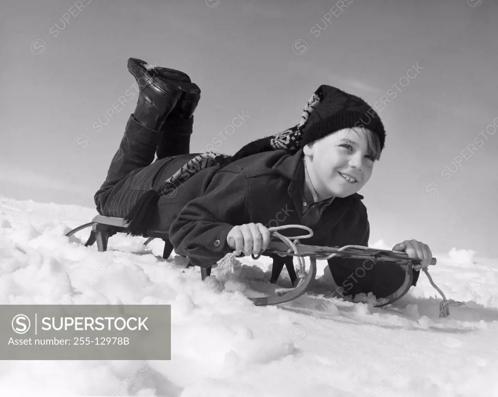 Boy sliding on a sled