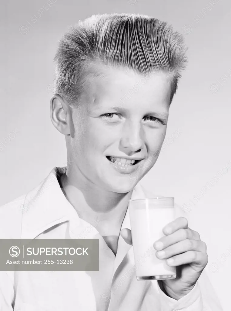Portrait of a boy holding a glass of milk
