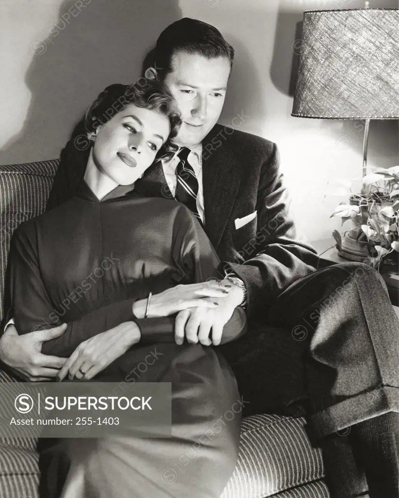 Mid adult couple embracing on a couch