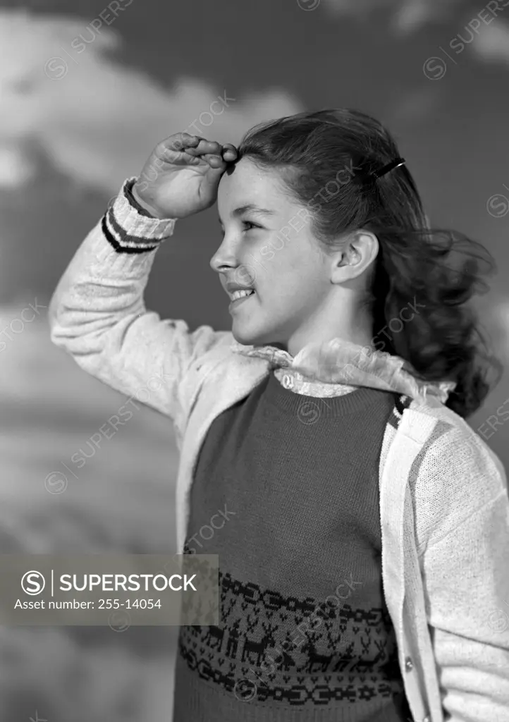 Girl looking up at clouds