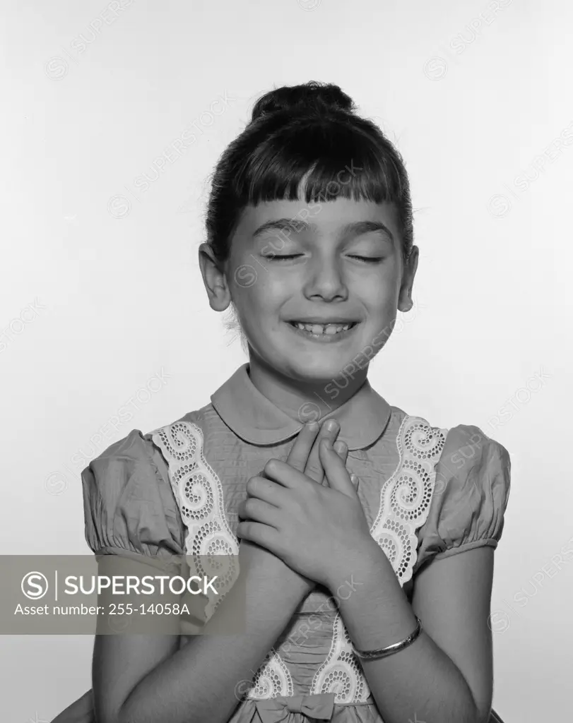 Studio shot of girl with hands on chest