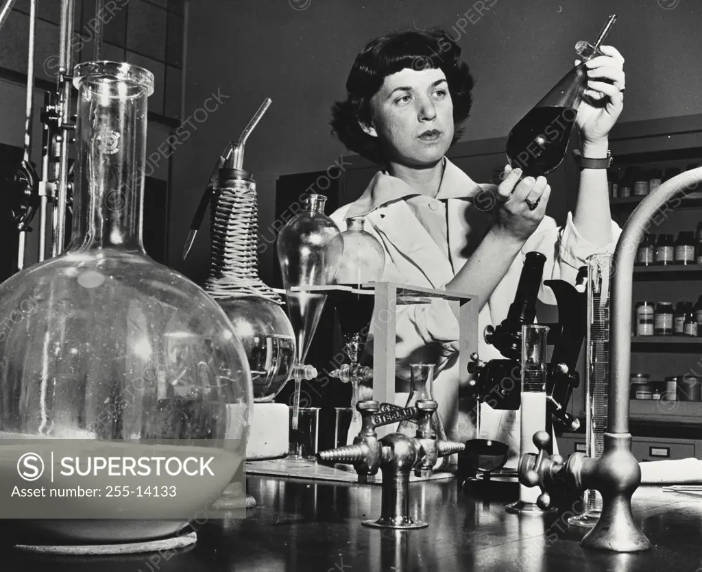 Vintage photograph. Research chemist making physical tests on oils and other organic materials at the manufacturing research laboratories