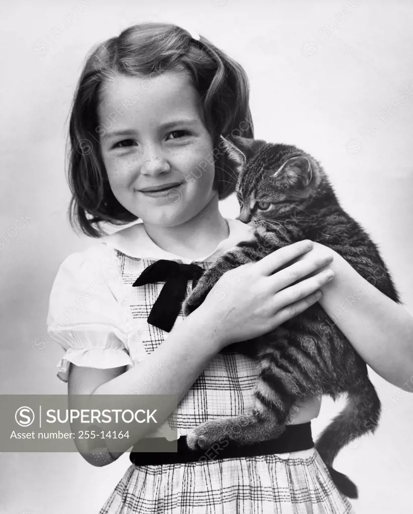 Girl carrying a cat