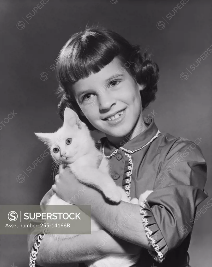 Close-up of a girl hugging her cat