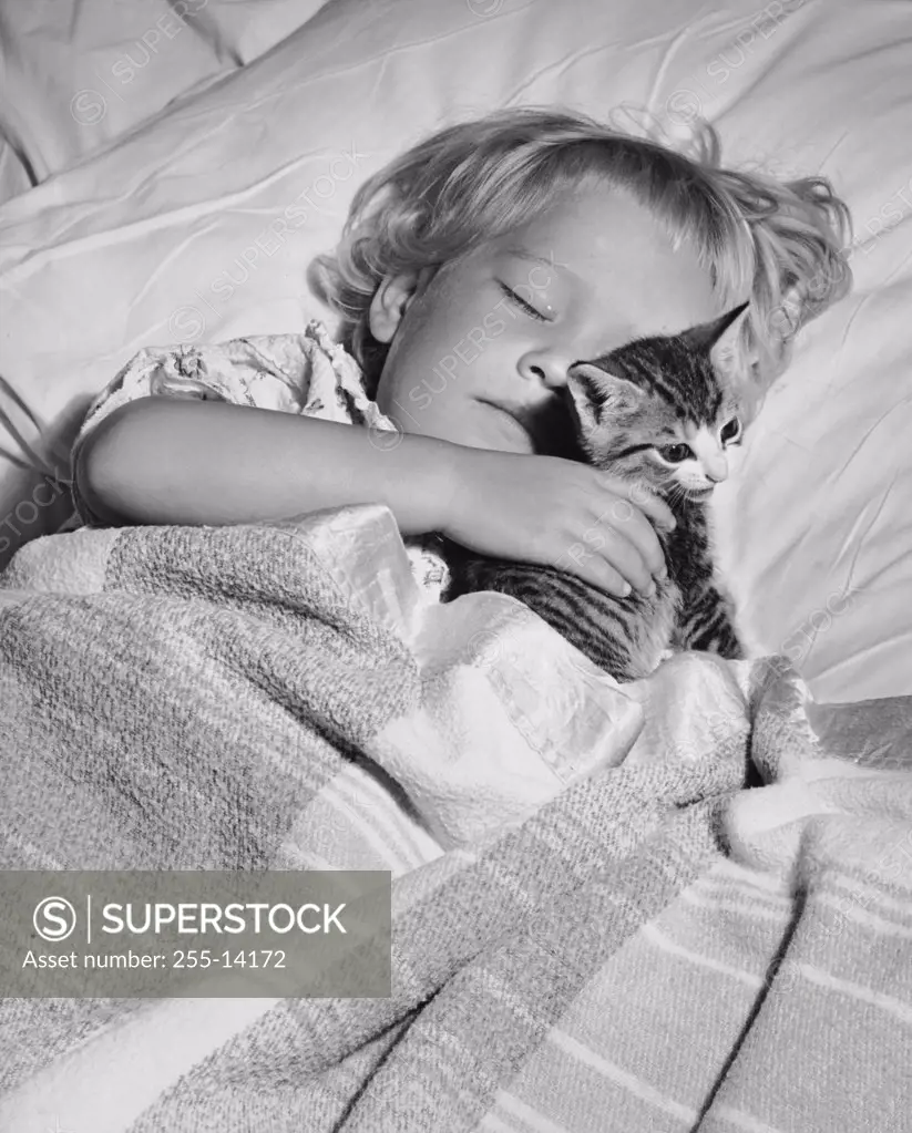 High angle view of a girl sleeping with a kitten
