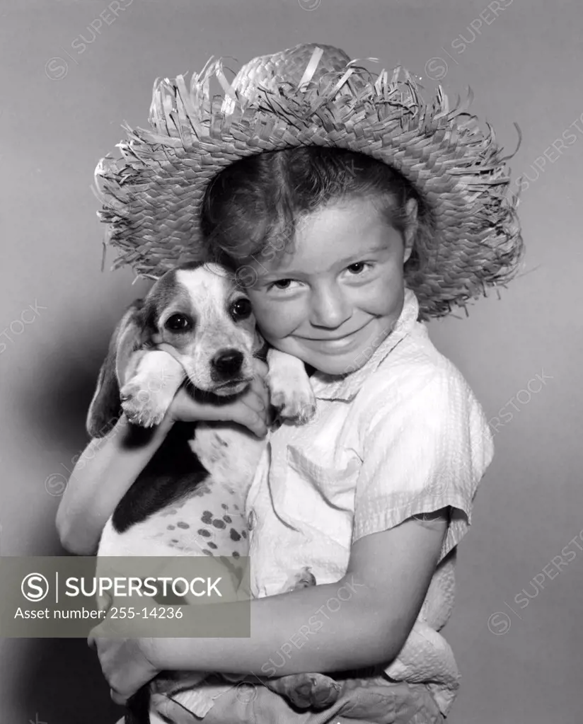 Studio portrait of girl embracing dog