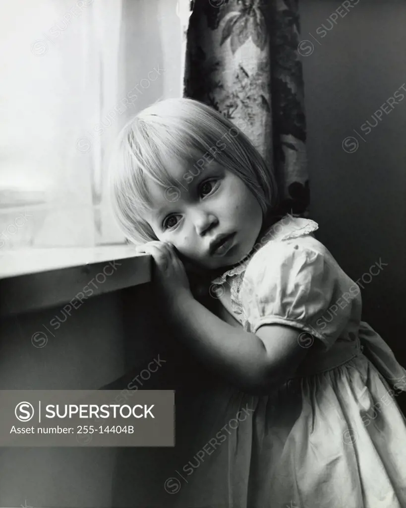 Side profile of girl standing near window