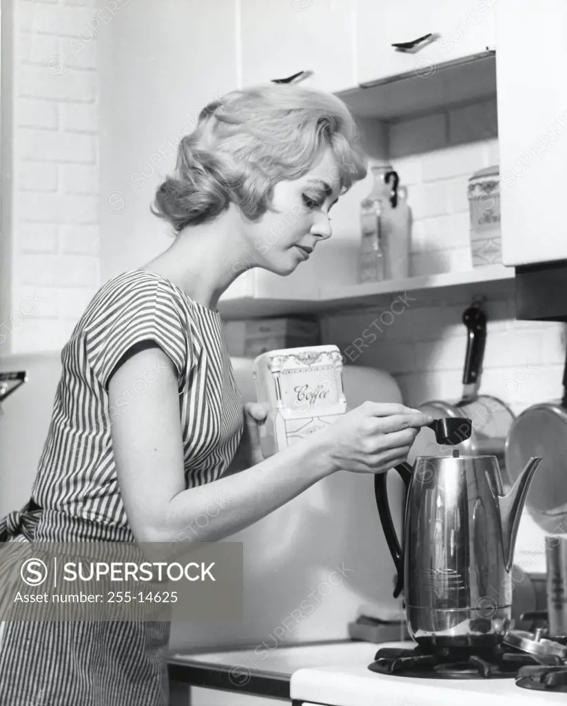 Side profile of a young woman preparing coffee