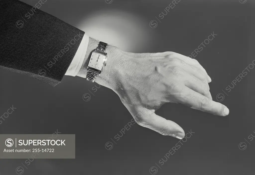 Vintage Photograph. Male hand wearing rectangular wristwatch, Frame 1