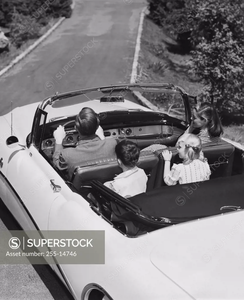 High angle view of a family traveling in a car