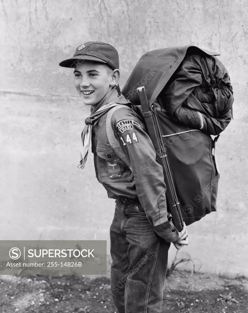Side profile of a boy scout carrying a backpack