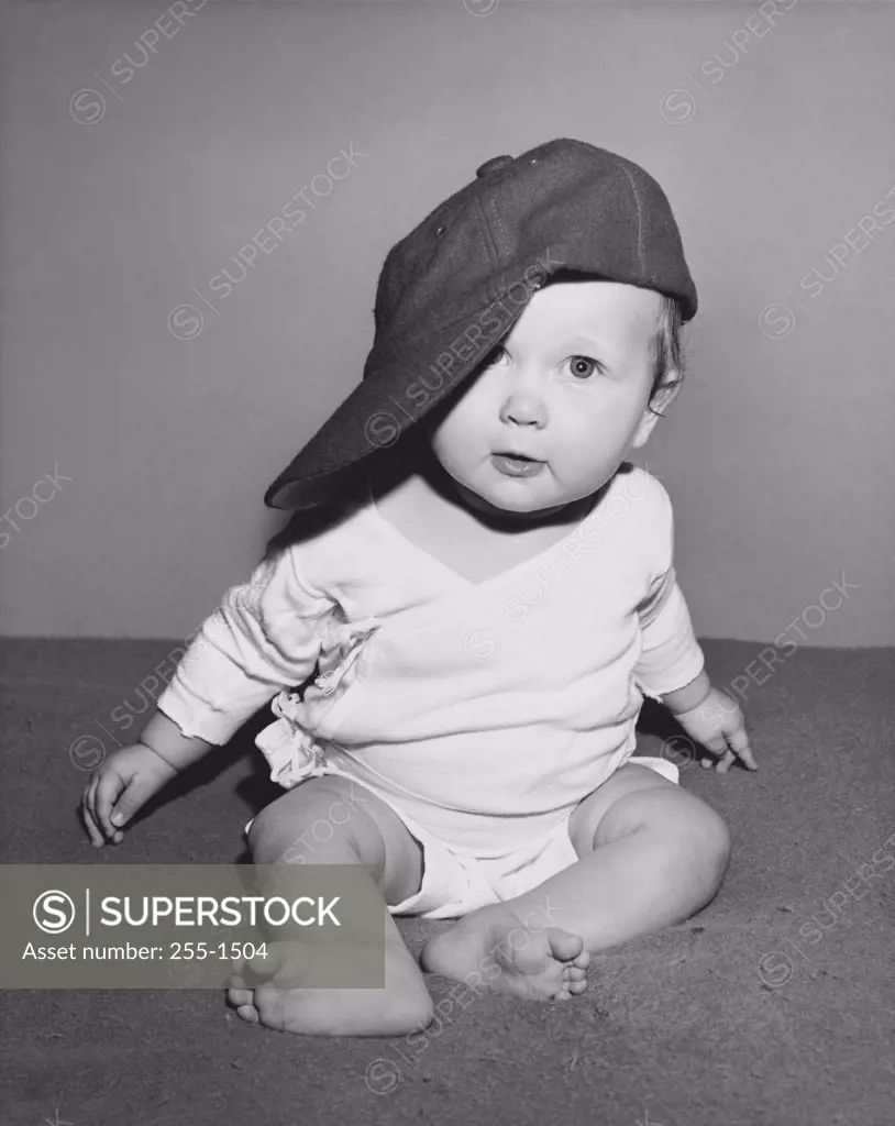 Baby wearing a baseball cap